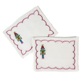 white scalloped cocktail napkins with embroidered nutcracker design
