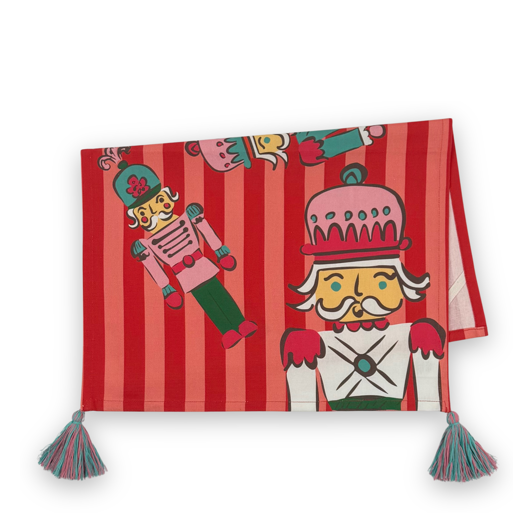 A folded rectangular red and pink striped tea towel, decorated with cartoon nutcracker illustrations and finished with two tassel ties at the bottom corners.