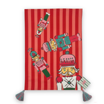 A rectangular red and pink striped tea towel, decorated with cartoon nutcracker illustrations and finished with two tassel ties at the bottom corners and a madcap cottage card on the bottom.