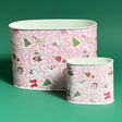 Empty duo of Nutcracker Ribbon Christmas caddies in large and small on a green background