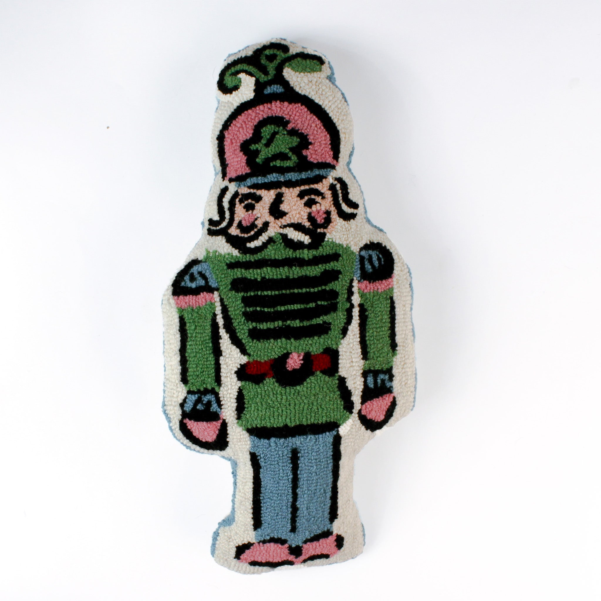 Decorative Christmas pillow shaped like a nutcracker soldier, featuring a pastel green uniform, pink and blue accents, and a detailed mustached face with a tall plumed hat.