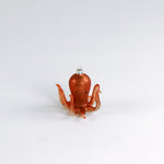 Decorative octopus glass christmas ornaments on a white background