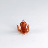 Decorative octopus glass christmas ornaments on a white background
