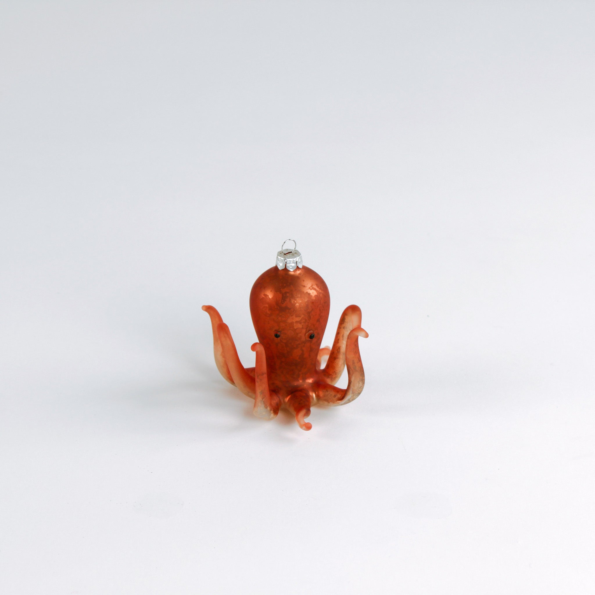 Decorative octopus glass christmas ornaments on a white background