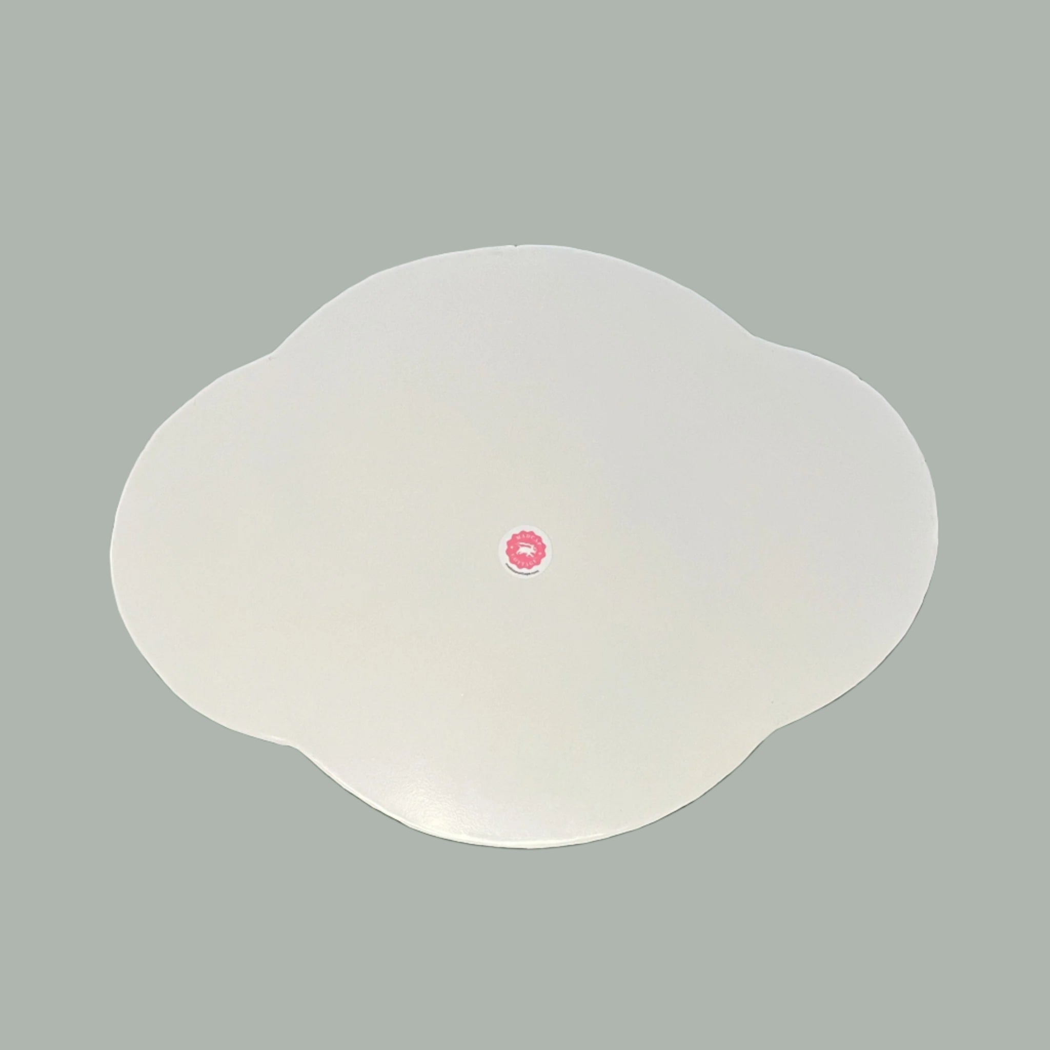 Reverse side of the Oh, Pagoda metal tole tray in a scalloped shape painted white.