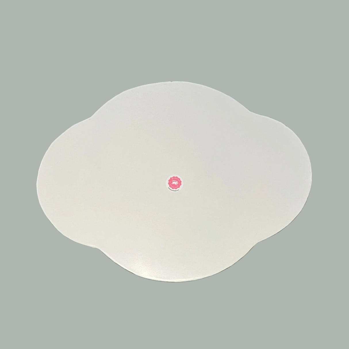 Reverse side of the Oh, Pagoda metal tole tray in a scalloped shape painted white.