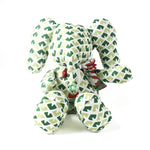 Green and white patterned stuffed elephant toy with a decorative bow.
