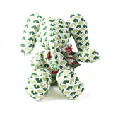 Green and white patterned stuffed elephant toy with a decorative bow.