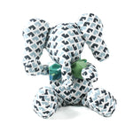 Blue and white patterned stuffed elephant toy with a green bow.