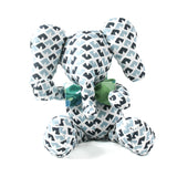 Blue and white patterned stuffed elephant toy with a green bow.