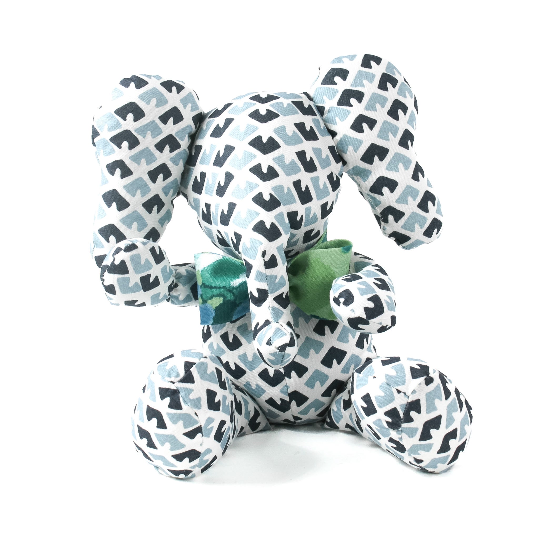 Blue and white patterned stuffed elephant toy with a green bow.