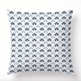 a square blue and white pillow featuring a triangle block print motif in dark blue and light blue. 