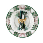 Old Peking chinoiserie dinner napkin in green and blue tones folded and styled on a white plate with a gold monkey napkin ring, displayed on a decorative green placemat for an elegant table setting alongside a Christmas tea towel.