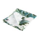 Folded Old Peking chinoiserie dinner napkin in green and blue tones featuring a scenic landscape pattern, neatly stitched edges, and soft fabric, styled for refined table settings and paired with a Christmas tea towel.