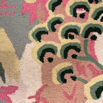 A close up of a chinoiserie motif on a pink and green rug from Madcap cottage