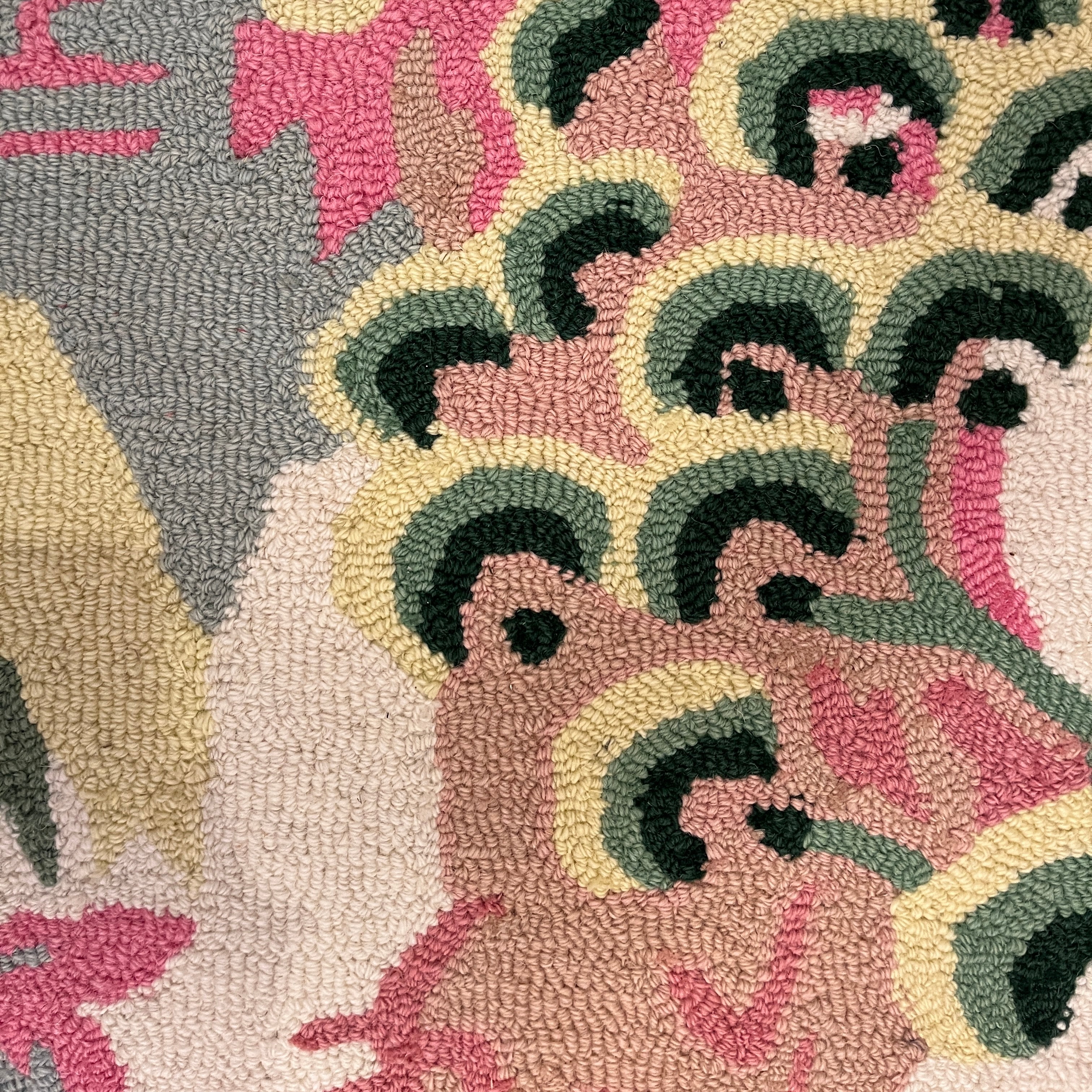 A close up of a chinoiserie motif on a pink and green rug from Madcap cottage