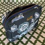 Open view of Temple Garden medium sized toiletry bag in navy blue features light blue floral motif.