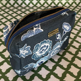 Open view of Temple Garden medium sized toiletry bag in navy blue features light blue floral motif.