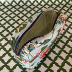 Open view of Meadow Club toiletry bag in sky blue features a lily pond pattern