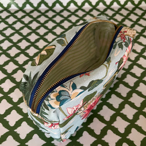 Open view of Meadow Club toiletry bag in sky blue features a lily pond pattern