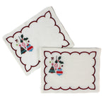 white scalloped cocktail napkins with embroidered Christmas ornaments