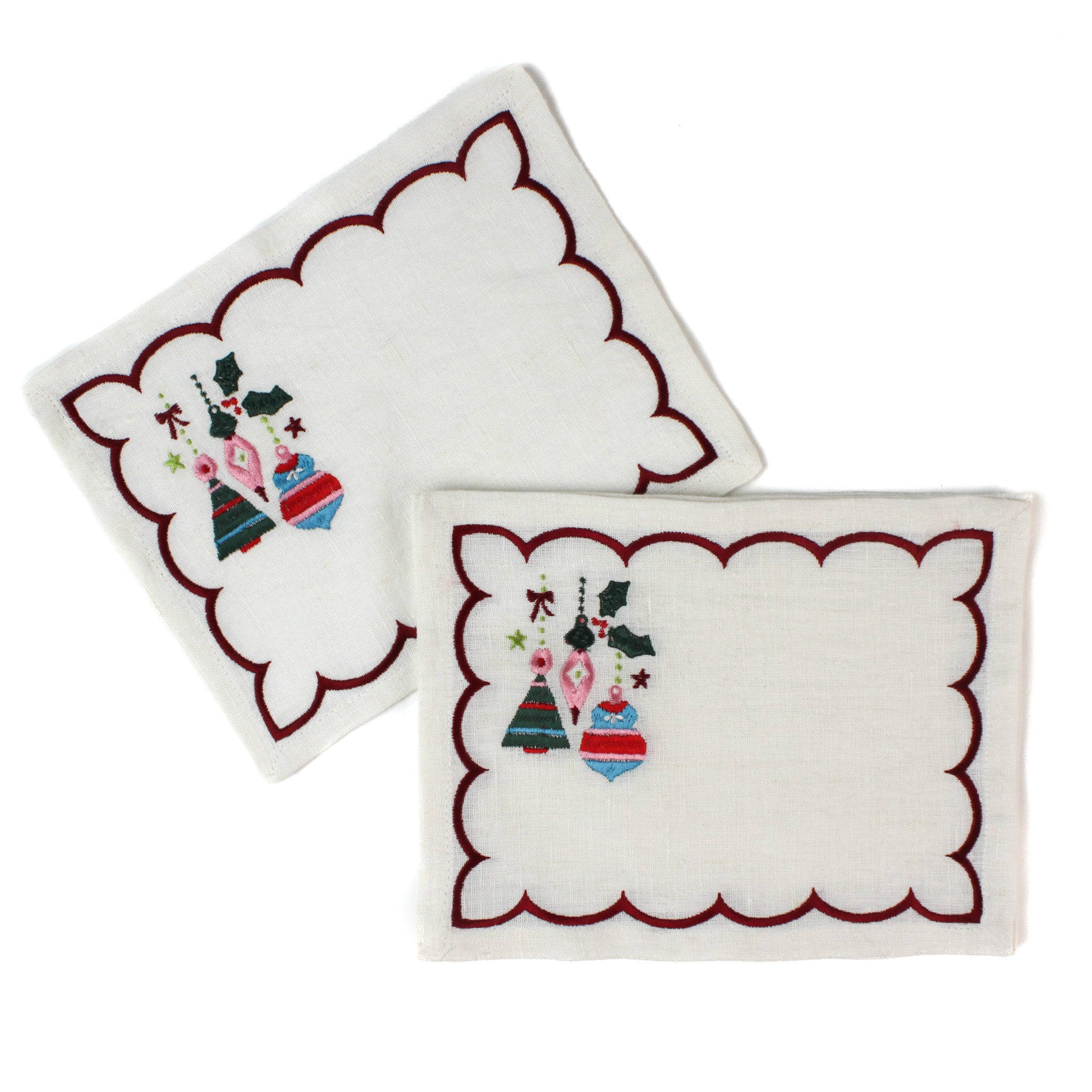 white scalloped cocktail napkins with embroidered Christmas ornaments