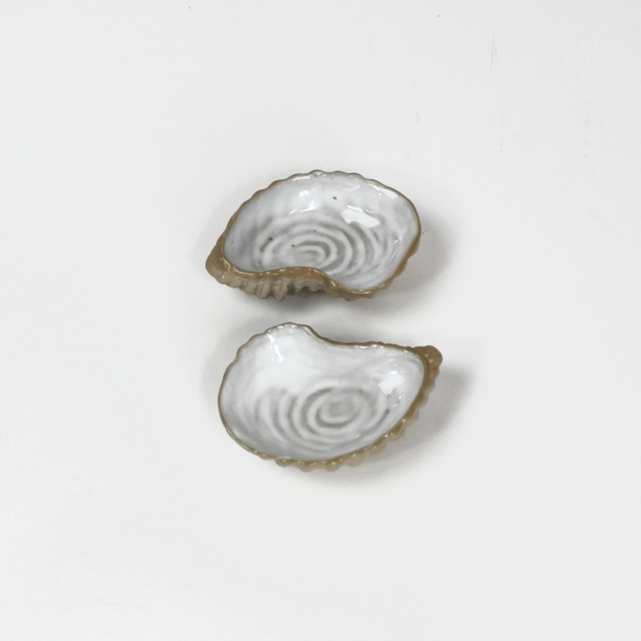 two ceramic oyster dishes  designed to look like oyster shells from madcap cottage