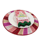 a pagoda designed place card on top of a napkin cloth, plate and rattan placemat