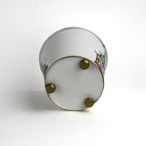 Bottom view of white tole cachepot with gold feet and gold-trimmed base.