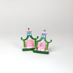 a pair of metal Pink and green chinoiserie napkin rings in the shape of pagodas from Madcap Cottage. 