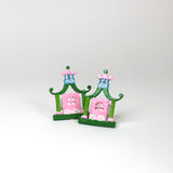 a pair of metal Pink and green chinoiserie napkin rings in the shape of pagodas from Madcap Cottage. 
