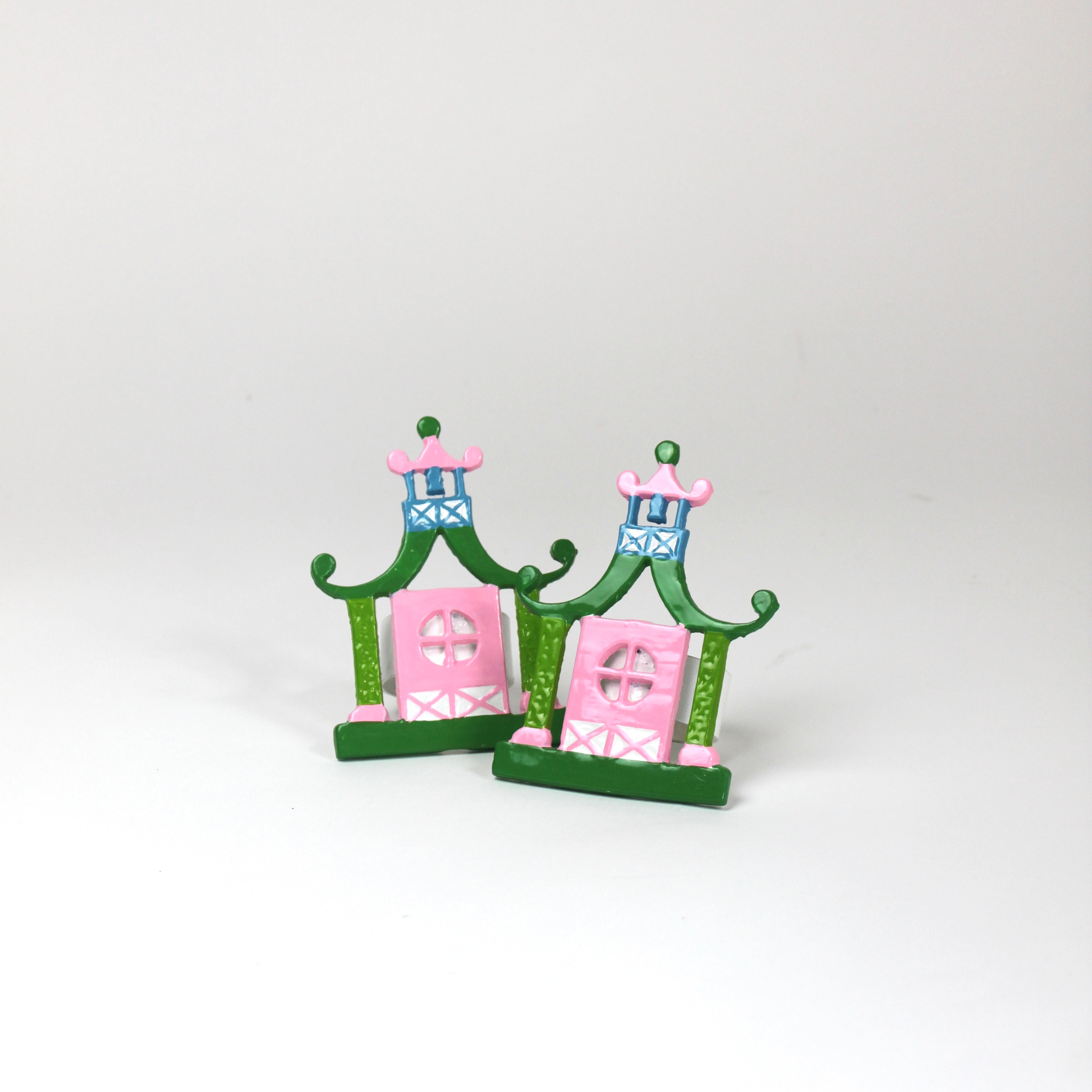 a pair of metal Pink and green chinoiserie napkin rings in the shape of pagodas from Madcap Cottage. 