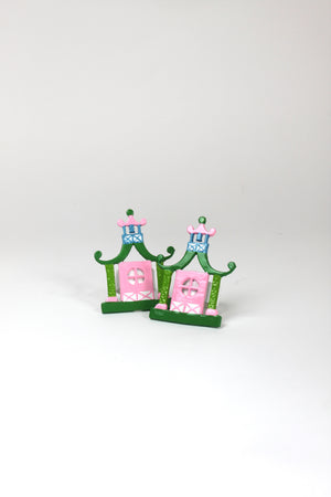 a pair of metal Pink and green chinoiserie napkin rings in the shape of pagodas from Madcap Cottage. 