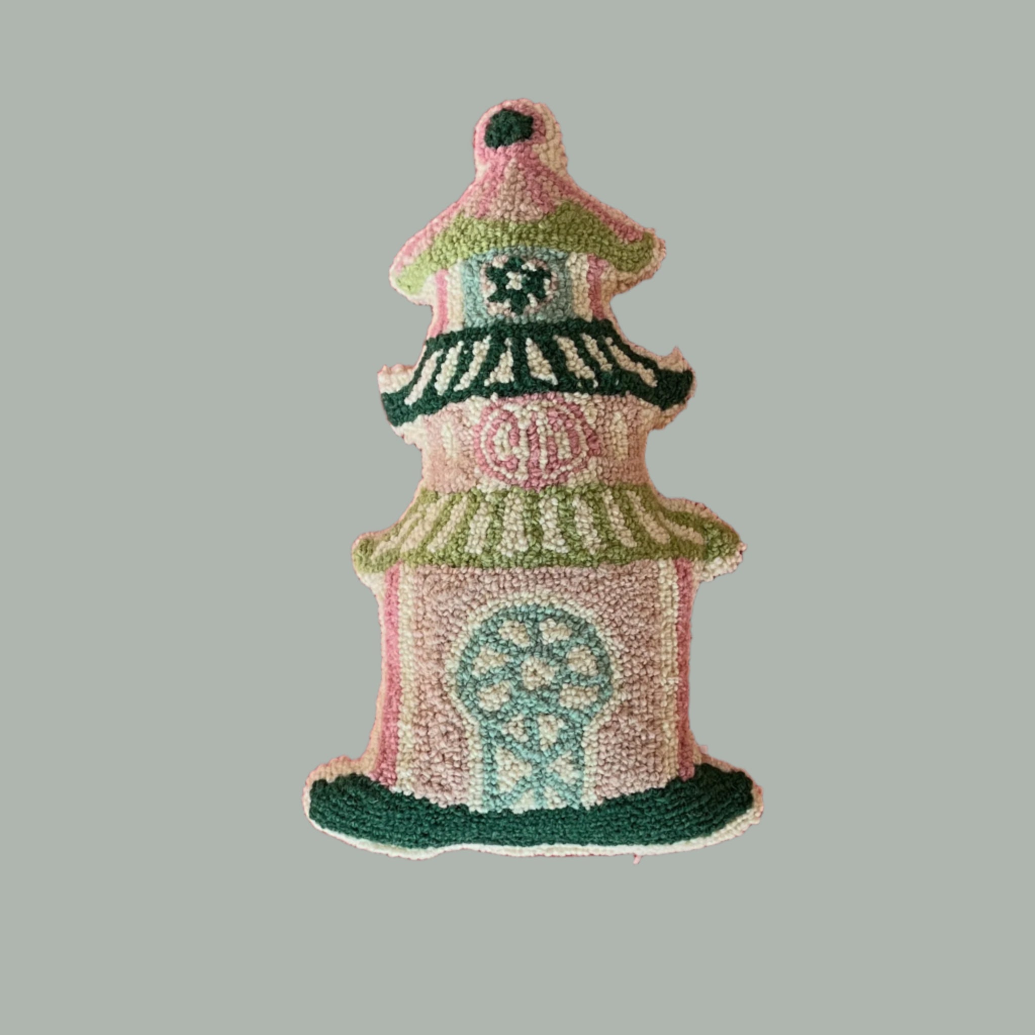 A mini pagoda pillow in pink and green