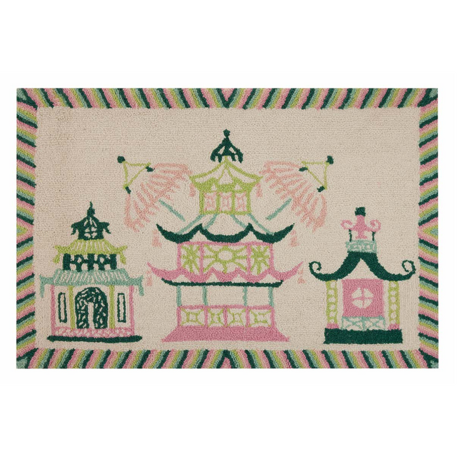 A rectangular pink and green rug with a trio of pagodas in the centre and a green striped border