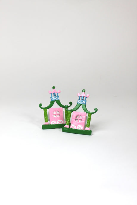 a pair of metal Pink and green chinoiserie napkin rings in the shape of pagodas from Madcap Cottage. 