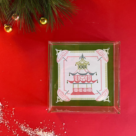 An acrylic tray featuring a green border and central pagoda motif. 