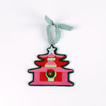 pink felt chinoiserie christmas ornaments in the shape of pagodas against a white background 