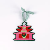 pink felt chinoiserie christmas ornaments in the shape of pagodas against a white background 