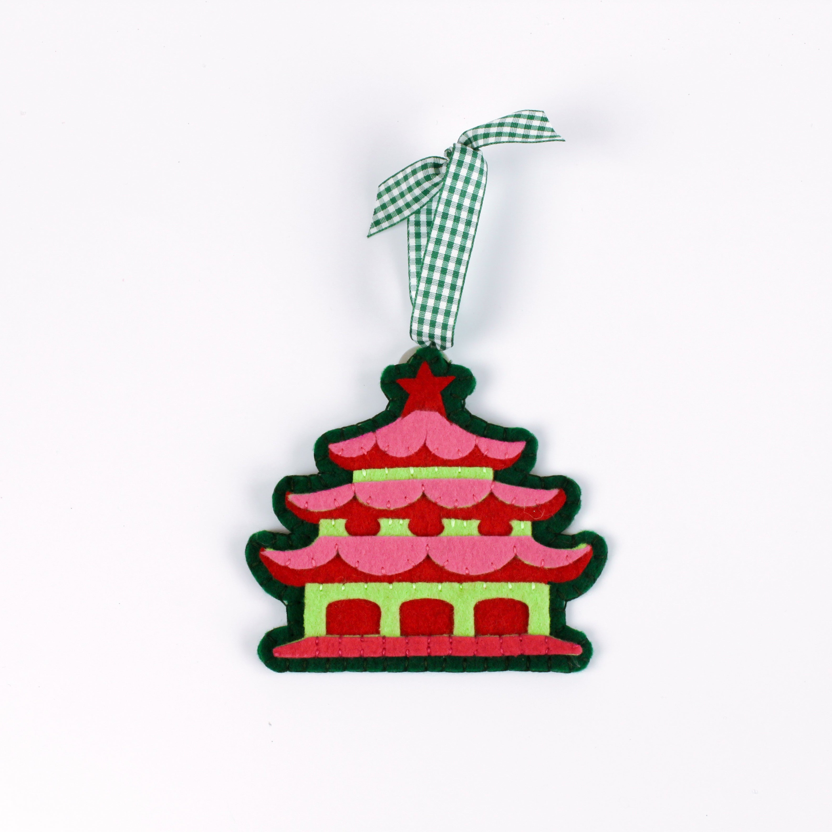 pink felt chinoiserie christmas ornaments in the shape of pagodas against a white background 