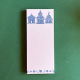 Pagodas Skinny Notepad in blue featuring illustrated pagoda designs and floral border in a green background