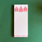 Pagodas Skinny Notepad in pink featuring illustrated pagoda designs and floral border in a green background