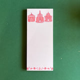 Pagodas Skinny Notepad in pink featuring illustrated pagoda designs and floral border in a green background