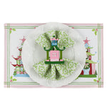 Festive Pagodas Rectangular Paper Christmas Placemats on a white surface. A white plate is placed on top of it with a cloth and a pagoda napkin ring