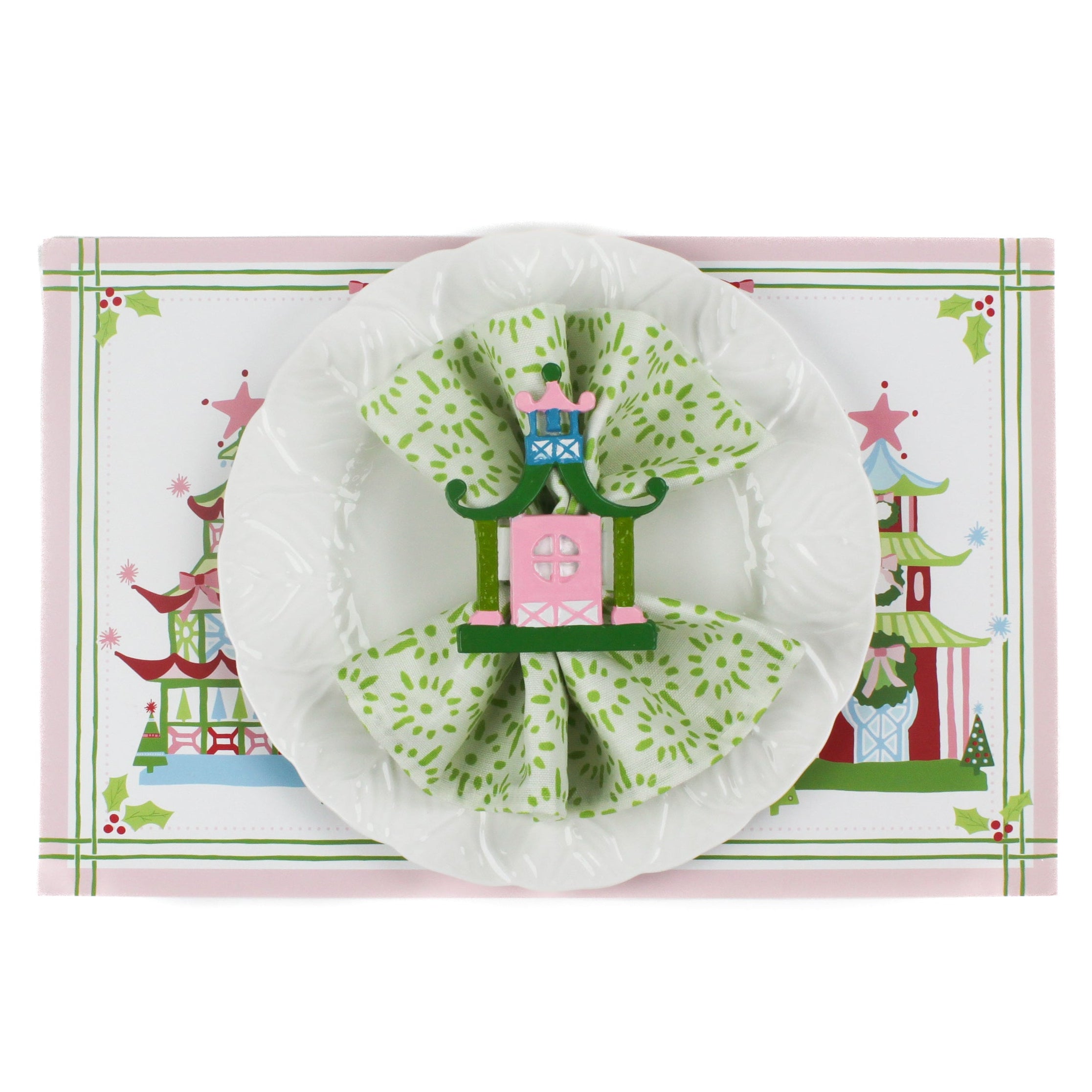 Festive Pagodas Rectangular Paper Christmas Placemats on a white surface. A white plate is placed on top of it with a cloth and a pagoda napkin ring