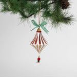 paper mache red striped christmas ornament on a white background