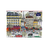 1000-piece Paris Metro cityscape puzzle box featuring illustrated Parisian buildings, Eiffel Tower, bustling street scene, and colorful storefronts.