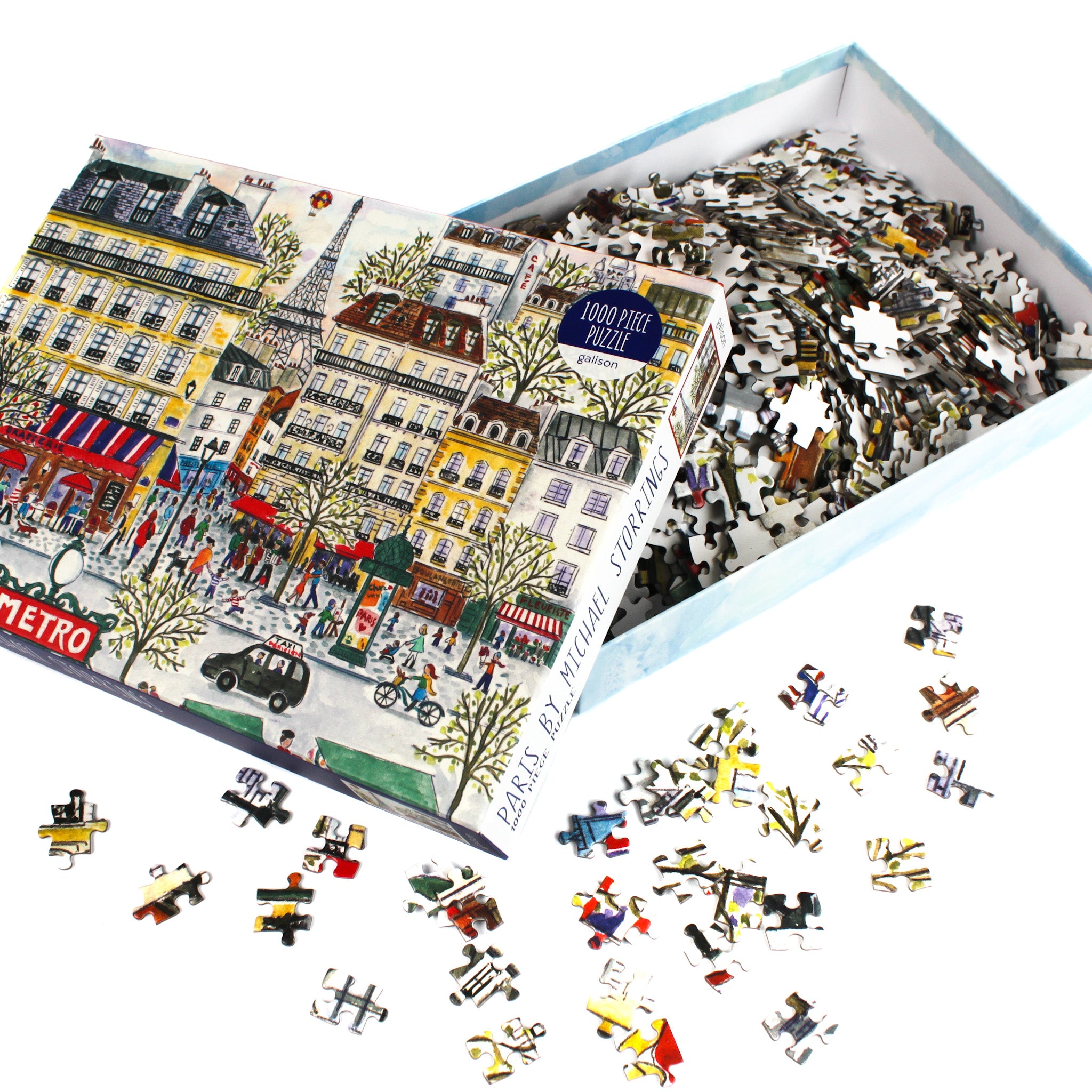 Galison 1000 piece foil jigsaw puzzle – Paris holiday market scene with Eiffel Tower, cafés, Christmas trees, and winter street artwork.