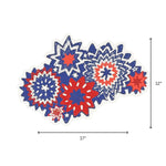 A patriotic starburst themed paper placemat in red white and blue displayed with 17" by 12" dimensions on a white background.