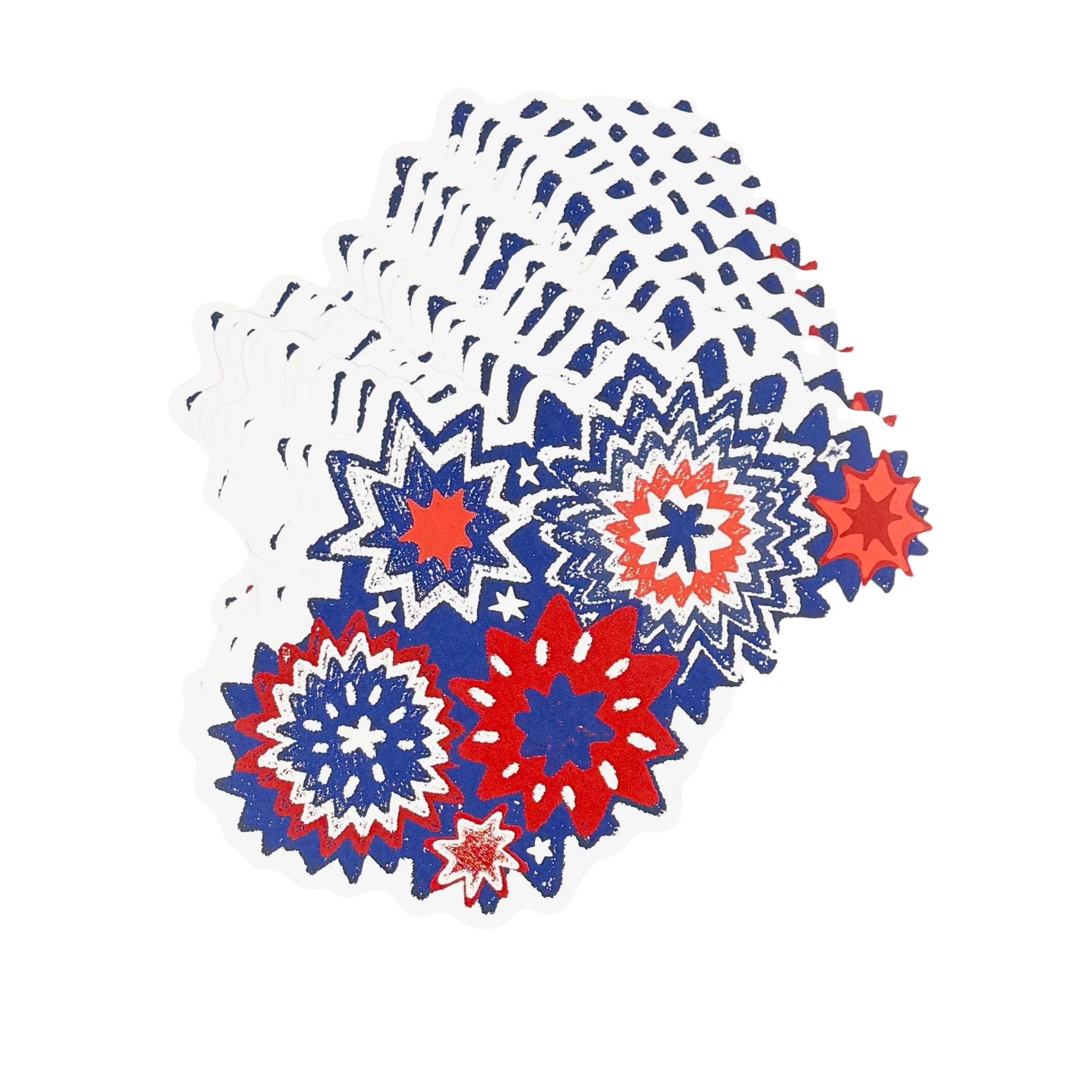 A stacked set of patriotic paper placemats featuring red white and blue starburst designs on a white background.